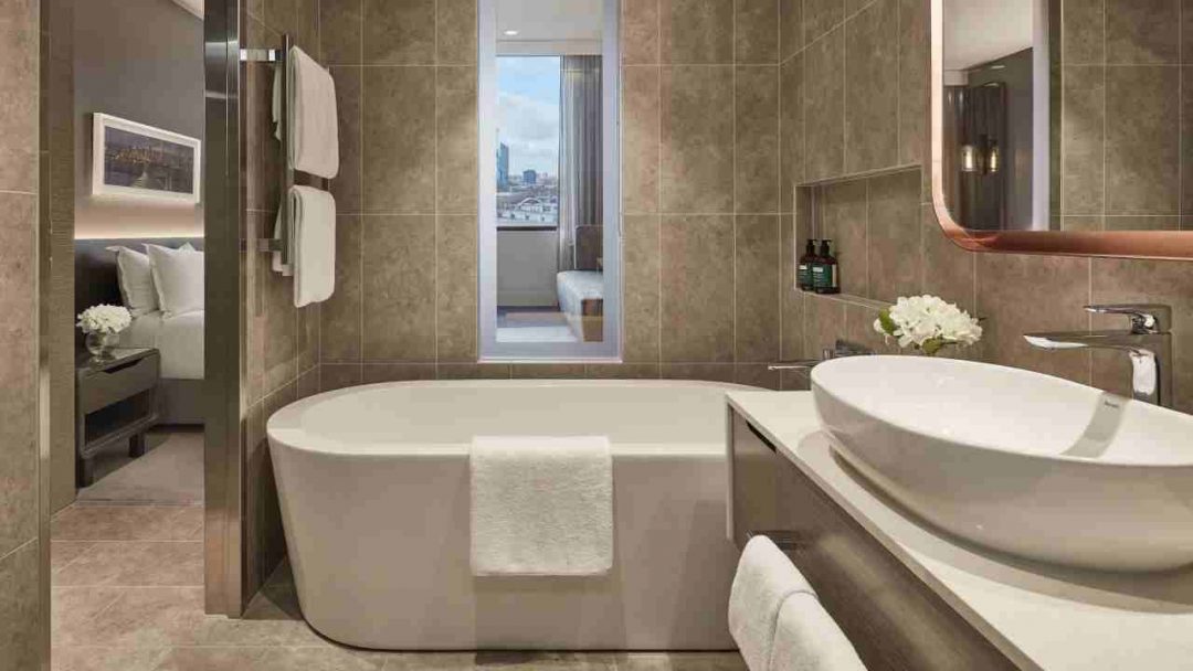 Luxury spa bathroom with Bath Tub, Basin and Flowers